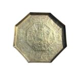 An octagonal brass tray, embossed with pair of medieval type figures in floral scrolled panel,