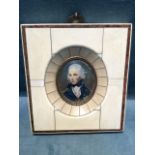 An oval bust portrait of Nelson under convex glass, with embossed brass border in a rectangular bone