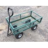 A rectangular trolley cart with drop-down sides on four pneumatic rubber tyres, the front with