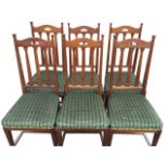 A set of six arts & crafts mahogany dining chairs, the arched backs with pierced rails above slats