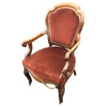 A European mahogany armchair with shield shaped upholstered back panel in moulded frame, above