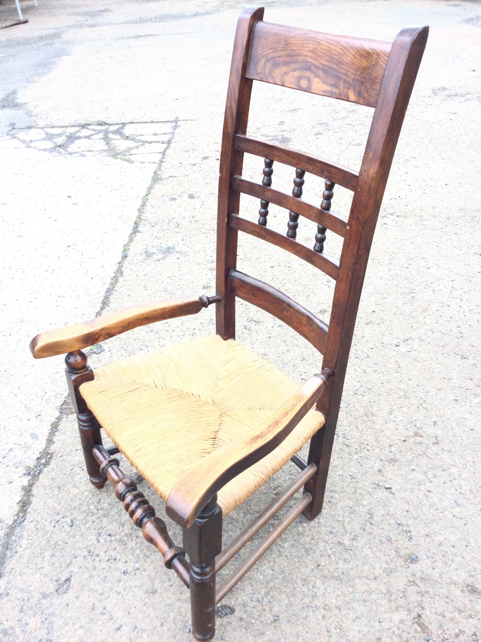 A country oak armchair, the back rails framing turned gallery spindles, above shaped arms and a rush - Image 3 of 3