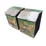 A pair of galvanised grain or log bins with angled hinged lids, the front panels painted with gilt