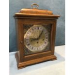 A Georgian style oak bracket clock, the case with moulded caddy top surmounted by brass handle,