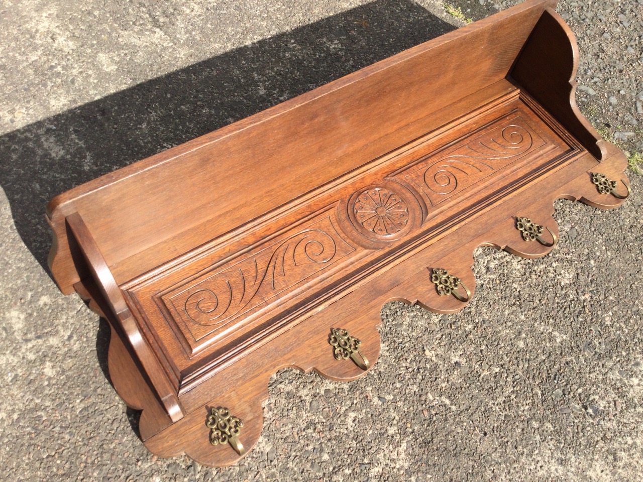 A late Victorian carved coat rack, having shelf on shaped supports above a scroll carved panel, with - Image 2 of 3