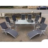 A contemporary rectangular garden table & chair set, the folding chairs with fabric backs & seats