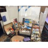 A collection of artists materials including paints, a folding easel, brushes, boxed sets of pastels,