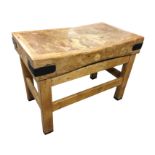 A rectangular butchers block, the panelled top with iron mounts, raised on rectangular legs &