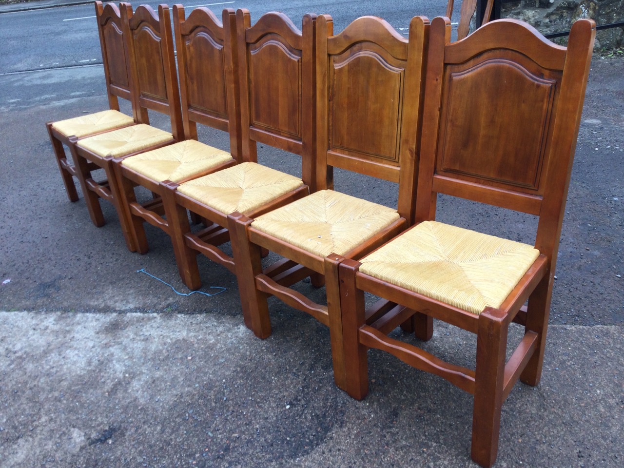 A set of six hardwood dining chairs with arched fielded panelled backs above drop-in rush seats, - Image 2 of 3