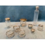 Nine glass bottles & pots with hallmarked silver mounts and covers/lids, including a pair of