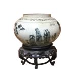 A Chinese stoneware bowl on stand, decorated with continuous landscape scene having figures