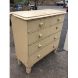 A Victorian painted pine chest of drawers, the rounded moulded top above two short and three long