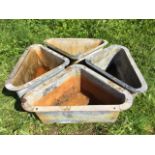 A set of four triangular galvanised corner feed troughs with flat rims. (28in x 17.5in x 11.5in) (