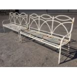 A pair of 5ft regency style garden benches with triple arched backs above slatted seats with