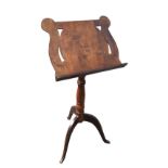 A mahogany music stand with adjustable angled reading platform on rise-and-fall turned column,