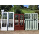A pair of glazed hardwood patio doors with bevelled glass panes, having arched tops and fielded