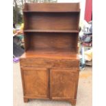 A mahogany secretaire bookcase with open shelves above a turn-over crossbanded desk with baize