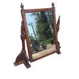 A late Victorian mahogany dressing table mirror, the moulded rectangular frame with bobbin finials