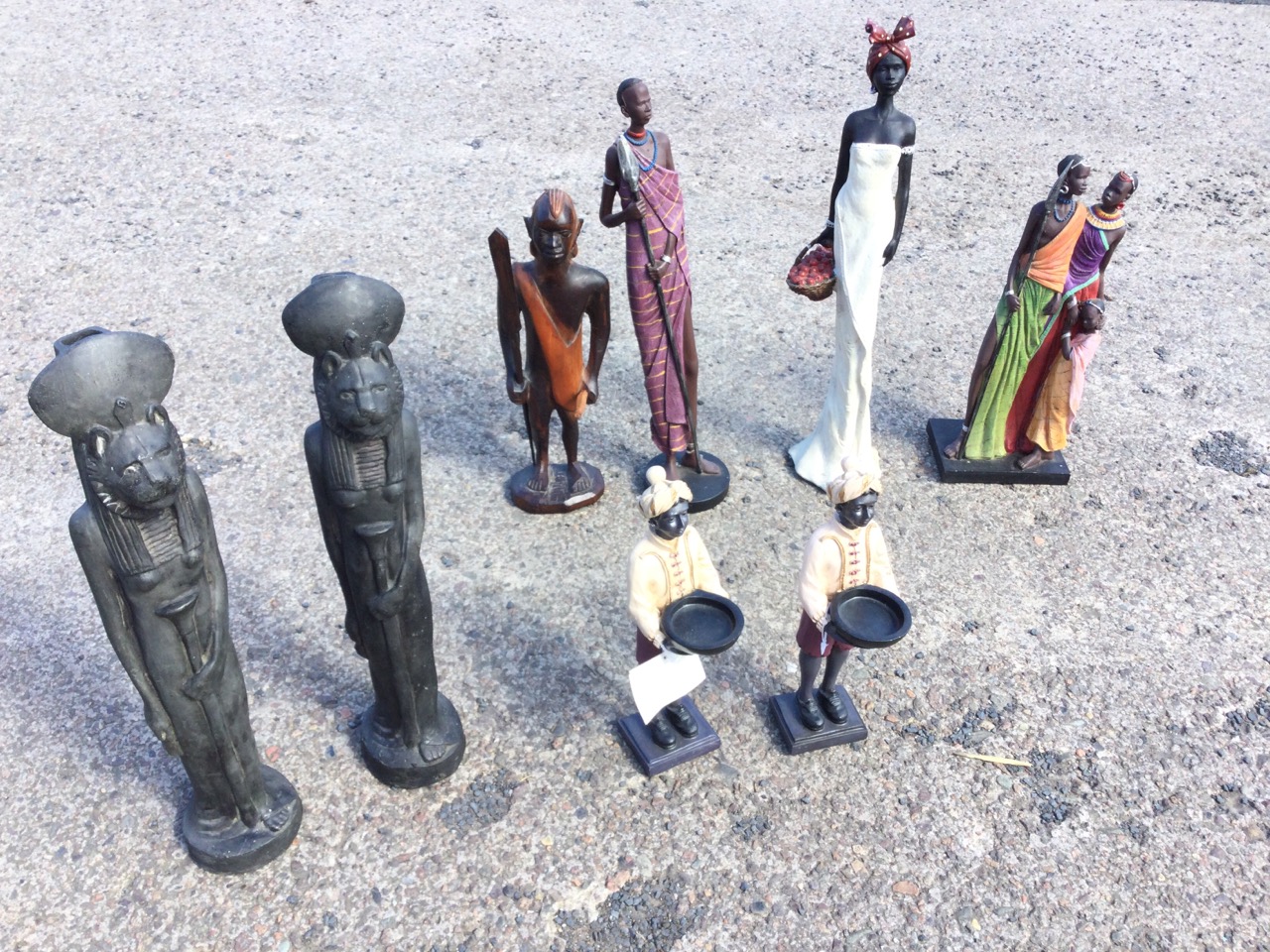 Four African tribal type figurines; a pair of Egyptian style lion vases; and a pair of blackamoor