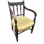 A nineteenth century elbow chair with reeded bar back above three fluted carved splats, the curved