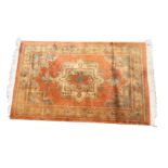 A thick-pile Turkey rug woven with serrated square medallion on orange field with charcoal