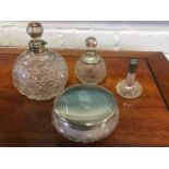 Three cut glass scent bottles with hallmarked silver mounts - one with missing stopper; and a cut