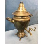 A nineteenth century Russian brass samovar mounted with turned hardwood handles on scrolled