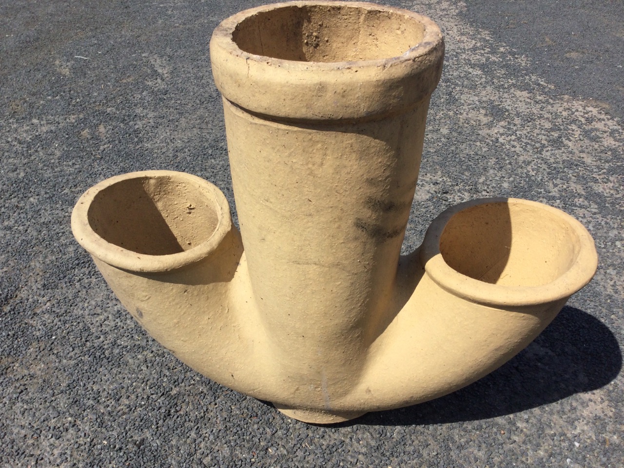 A stoneware pipe with central tube having two shaped side apertures. (22in)