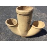 A stoneware pipe with central tube having two shaped side apertures. (22in)