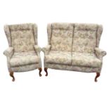A floral brocade upholstered wingback sofa & armchair, with button upholstery to backs and loose