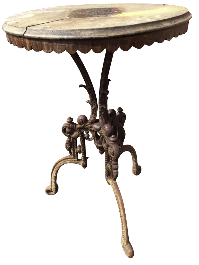 A circular Victorian cast iron table with ropetwist cast tripod legs centered by a scrolled urn, the