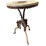 A circular Victorian cast iron table with ropetwist cast tripod legs centered by a scrolled urn, the