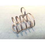 A hallmarked silver four division toastrack, with five hoops surmounted by ring handle -