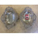 A pair of hallmarked silver bon-bon dished of oval scalloped form with pierced borders and foliate