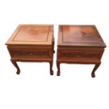 A pair of square mahogany bedside cabinets, the panelled tops above frieze drawers carved with