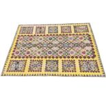 An Edwardian rectangular patchwork cotton quilt, hand sewn with octagonal floral and butterfly
