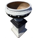 A large painted stoneware urn on stand, the fluted bowl shaped pot moulded with leaf rim supported