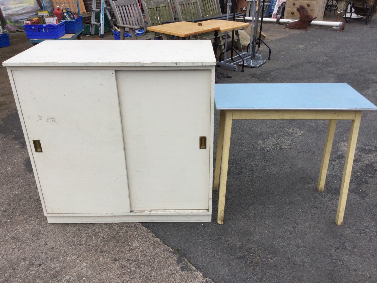 A rectangular painted cabinet with sliding doors, having brass handles enclosing shelves; and a - Image 2 of 3