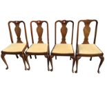 A set of four Queen Anne style walnut dining chairs with vase shaped splats above drop-in