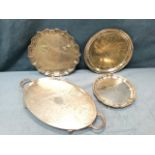 A silver plated scalloped waiter with gadrooned rim on three paw feet; an oval foliate engraved tray