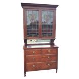 A late Victorian stained glass bookcase cabinet with moulded dentil cornice above leaded glazed