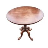 A mahogany occasional table, the circular top on turned tapering column with quadripartite legs on