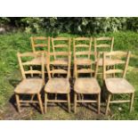 A set of eight elm ladderback church type chairs, with solid seats raised on turned legs &