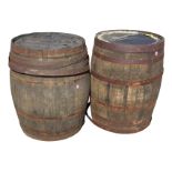 A pair of large oak whiskey barrels, the staves bound by riveted strap bands - some loose. (34.75in)