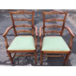 A pair of craftsman made eighteenth century style oak ladderback armchairs, the backs with four