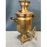 A twentieth century Russian brass samovar, the tubular urn above a burner with square base on