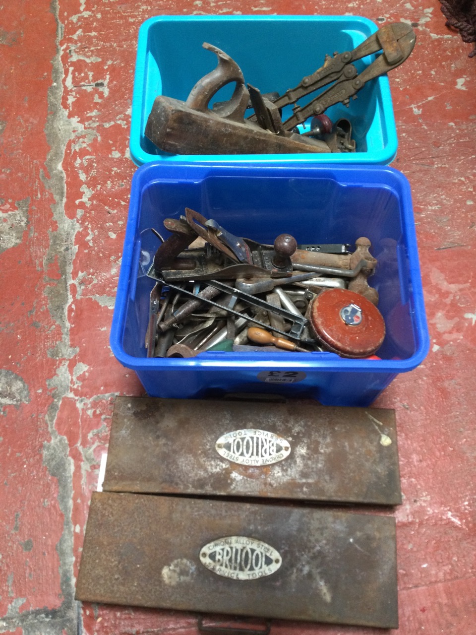 Miscellaneous tools including two cased socket sets, wood handled augers, spanners, hammers, a