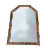 A contemporary rectangular mirror with canted top corners, in floral cushion moulded frame within