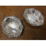 A pair of oval hallmarked silver bon-bon dishes of octagonal scalloped form with pierced sides,