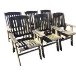 A set of six teak garden armchairs with arched back rails above slatted backs & seats, having